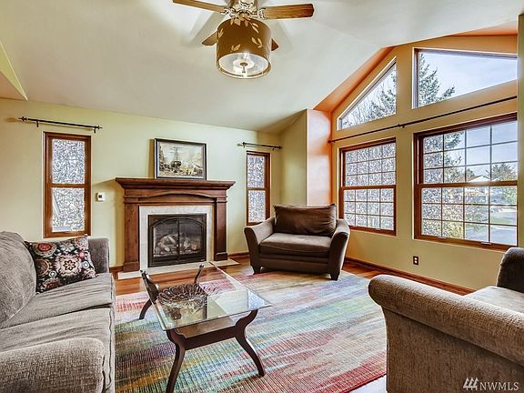 Custom Fireplace and ceiling fan and hardwood floors.