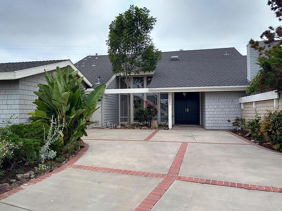 Large driveway leads to two car garage