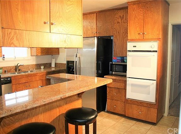 Upgraded kitchen with granite counter tops, large breakfast bar & double oven!