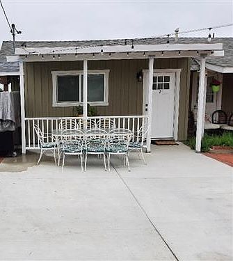 Front covered patio and entry. Tenant parking space. 1 Assigned space plus street parking.