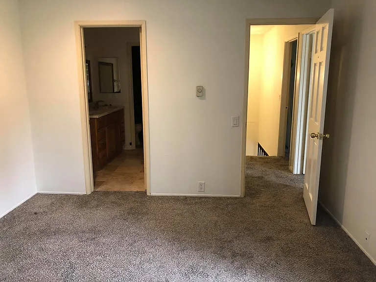 Master bedroom looking out to hallway and upstairs full bathroom