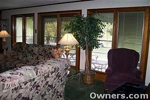 The living room has a wall of windows for a great view of the lake!