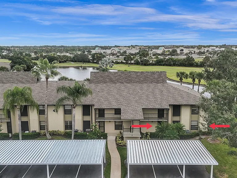 1st floor, END UNIT w/ stunning lake & golf views! 1 assigned covered carport parking space!
