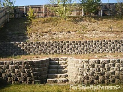 BACKYARD
						:
						landscaped with two tier retaining walls,with fence and lot of space.
