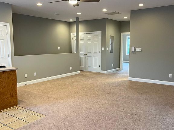 Come up the stairs and enjoy this airy and light living room connected to the kitchen. Closet at top of stairs has the laundry unit with storage.