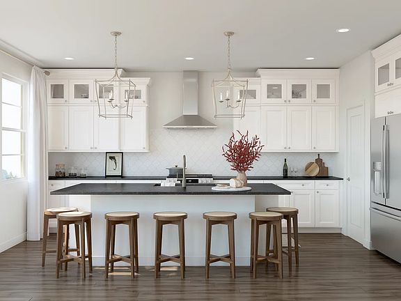 Kitchen with island, pendant lighting and glass upper cabinets