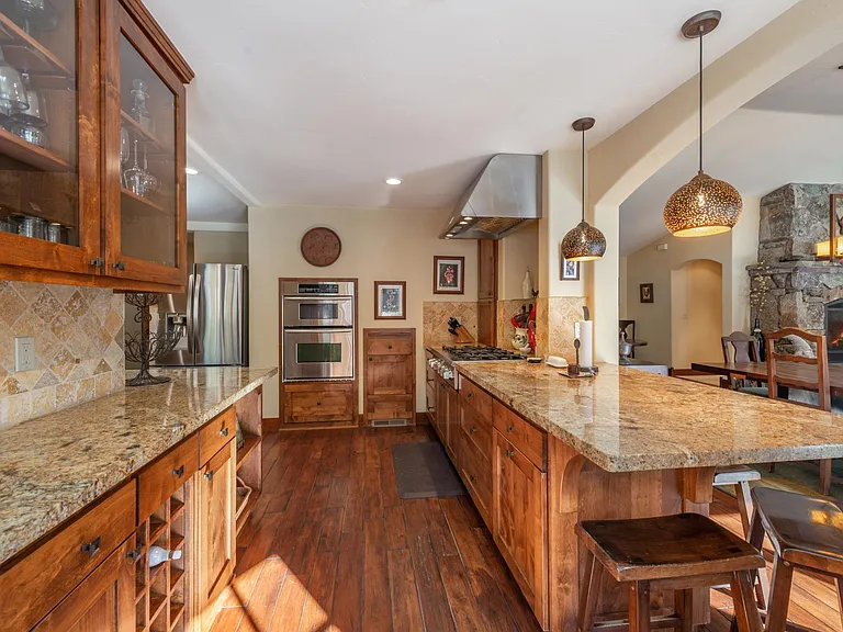 Large kitchen with granite counters, gas range, oven, microwave, extra large refrigerator