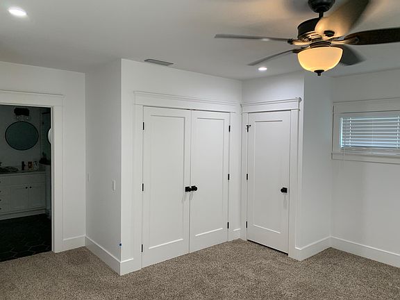 primary bedroom closets and suited bathroom entrance pictured