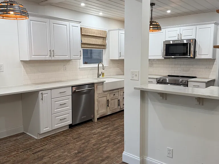 Spacious kitchen with quartz countertops and brick floors