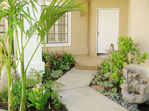 Beautiful tiled entry with fountains and exotic plants