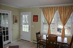 Eat-in kitchen with views of the backyard and walkout to deck