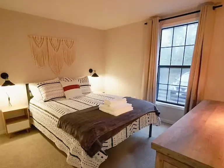 Evening photo-Private Furnished Bedroom (11x10'): Queen size bed with dresser, two nightstands, private closet, and room darkening curtains. Located on the 2nd floor along with a private full bath.