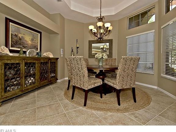 Elegant formal dining room with tray ceiling.