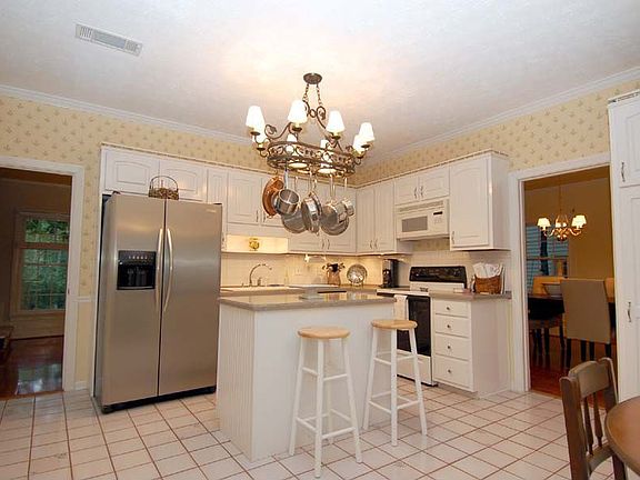 Spacious kitchen w/ solid surface countertops, tile floor, 