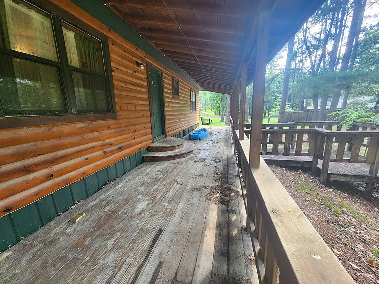 Covered back porch with party lights and porch swing.