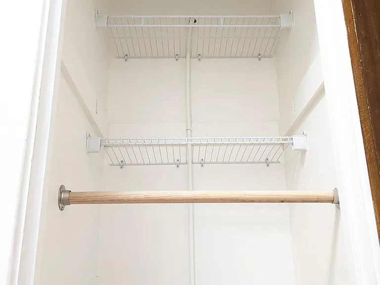New custom closet with double hanging closet rods and tons of storage space
