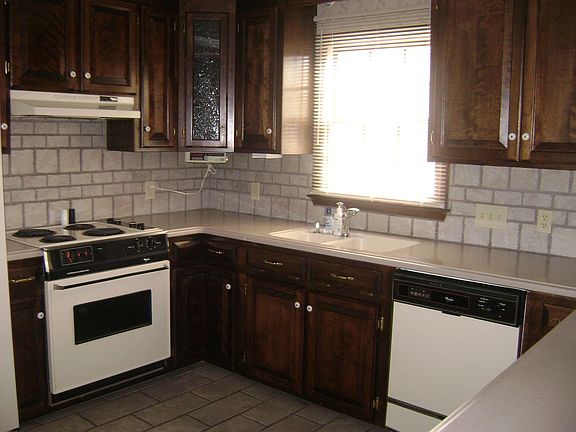 Kitchen has an abundance of custom cabinets, as well as solid surface.