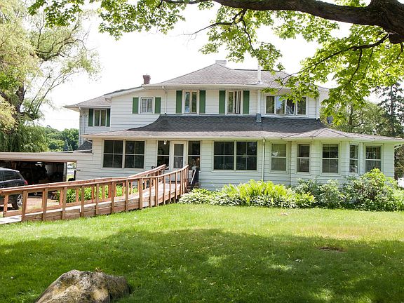 Front of home with wheelchair ramp for handicap accessibility.