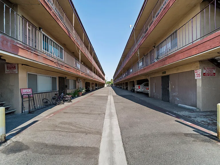 Wide driveway offering easy access to on-site parking for residents.