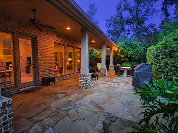 Wrap around covered porch with extended flagstone patio.