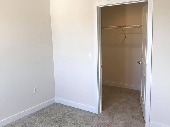 Bedroom featuring walk in closet
