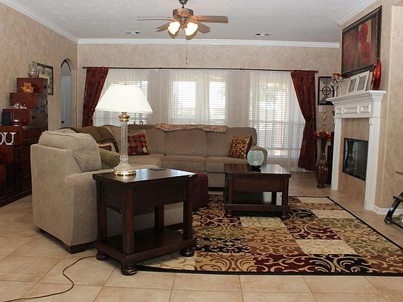 Spacious Den w/tile flooring, gas fireplace & big windows that look out to the backyard.