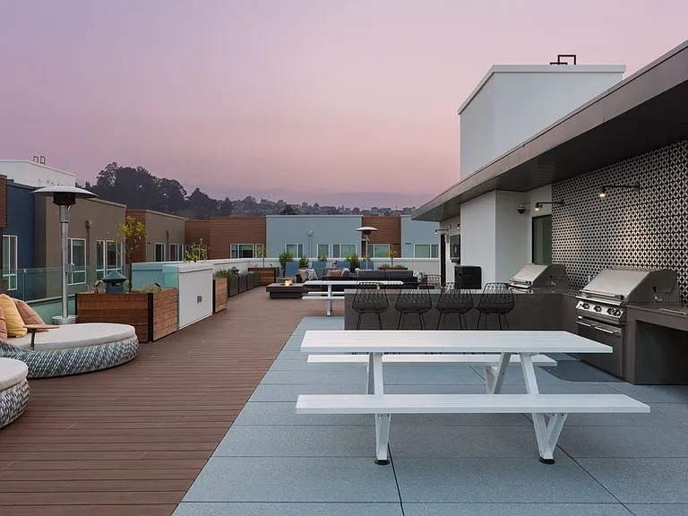Rooftop deck with barbecue grills and common area seating