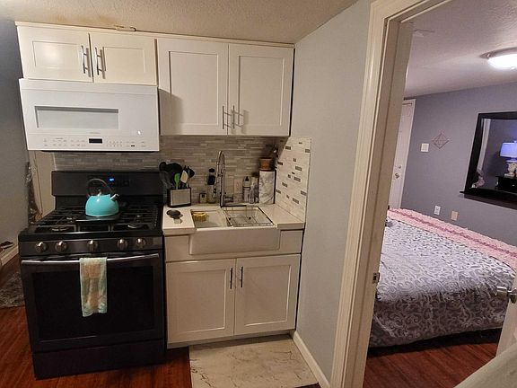 new kitchen sink, stove, microwave and cabinets