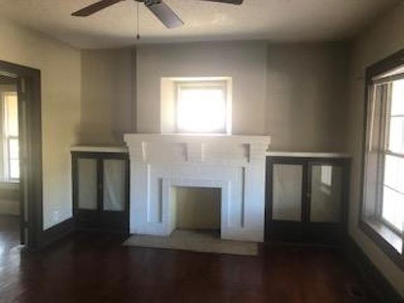 Main living room with original wood floors and built-in cabinets, original woodwork. Sunny North and Western exposure.