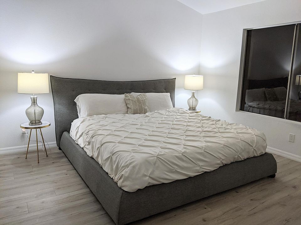 Master Bedroom Furnished with Cal King Bed. Private attached bathroom renovated with real white carrara marble countertops and mosaic tile shower
