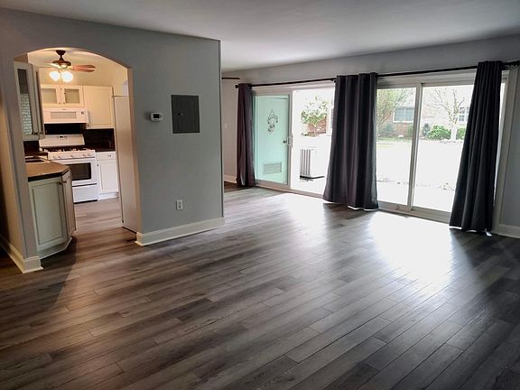View of kitchen and dining room from living room. Double sliders to private patio.