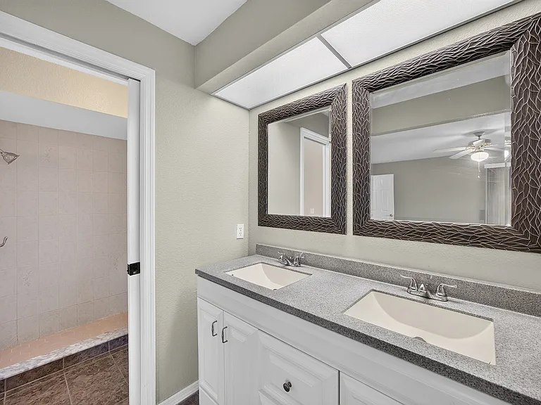 Dual sink vanity in the primary bedroom and large walk in closet.