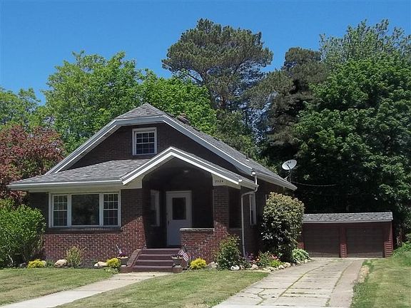 Brick bungalow w/ landscaping. Now has a new driveway.