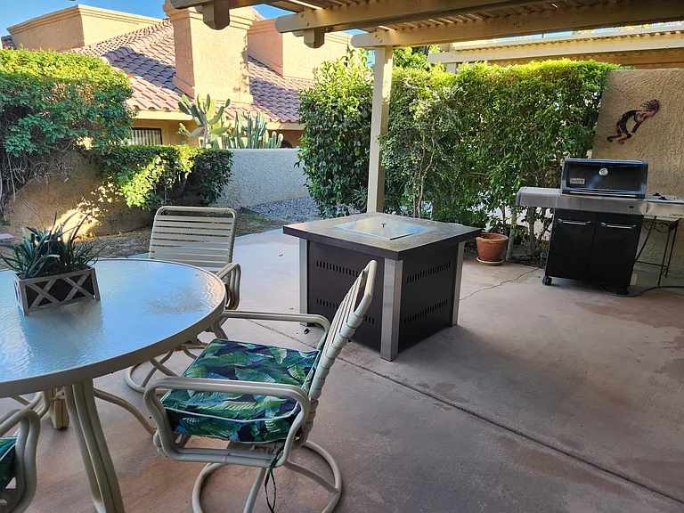 Large private patio with firepit and views of lake, golf course and mountains