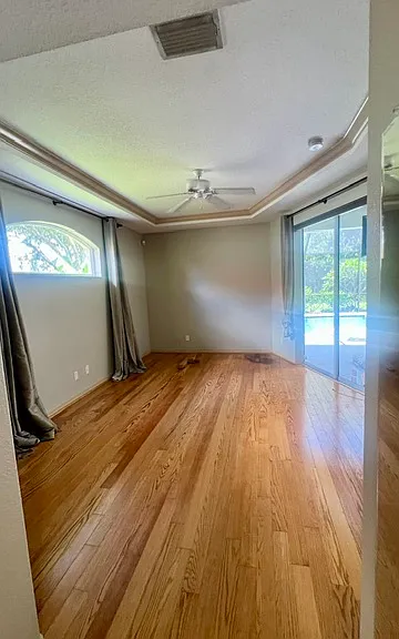 Primary bedroom with private entrance space, dual doors, walk in closet, linen closet, and pocketing sliding doors onto the lanai. A renter's dream of life!! Blinds and black out curtains for convenience only.