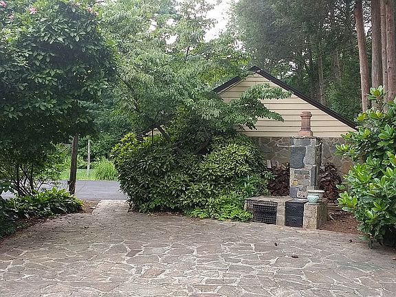 stone patio (garage in view)
