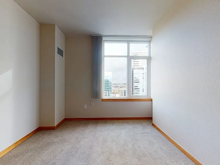 Spacious apartment bedroom with plush carpet flooring