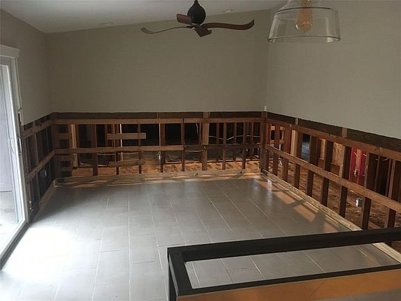 View of the den adjoining the kitchen looking out on to the back yard - after Harvey.