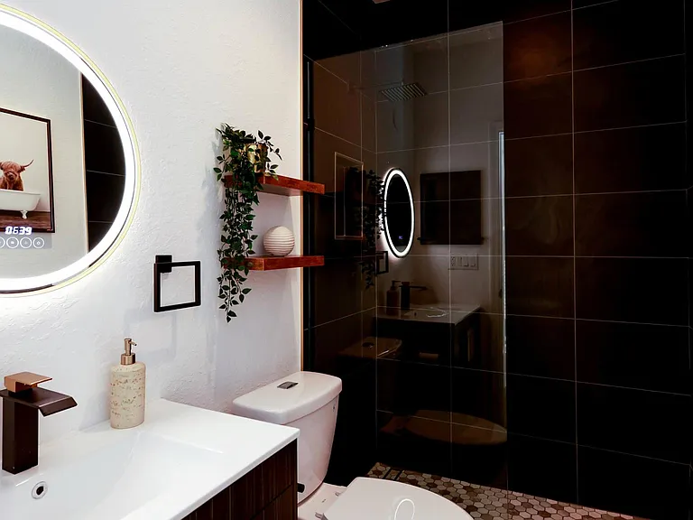 The modern style bathroom has a relaxing rain shower
