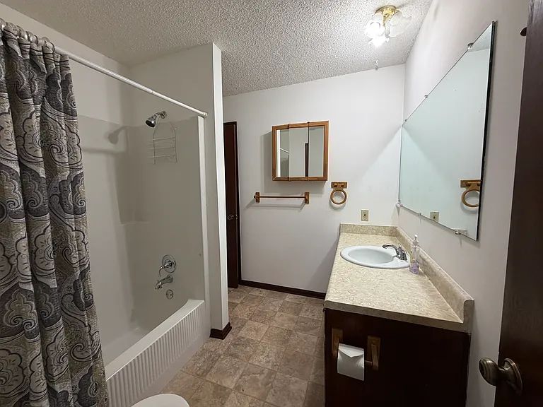 Bathroom with two entries (main hallway and primary bedroom)