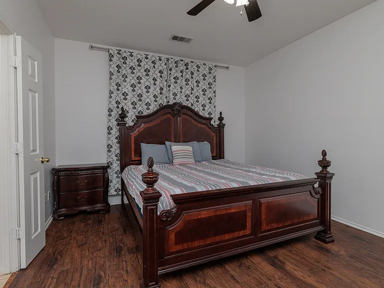 Primary bedroom with kind size bed and attached primary bathroom.