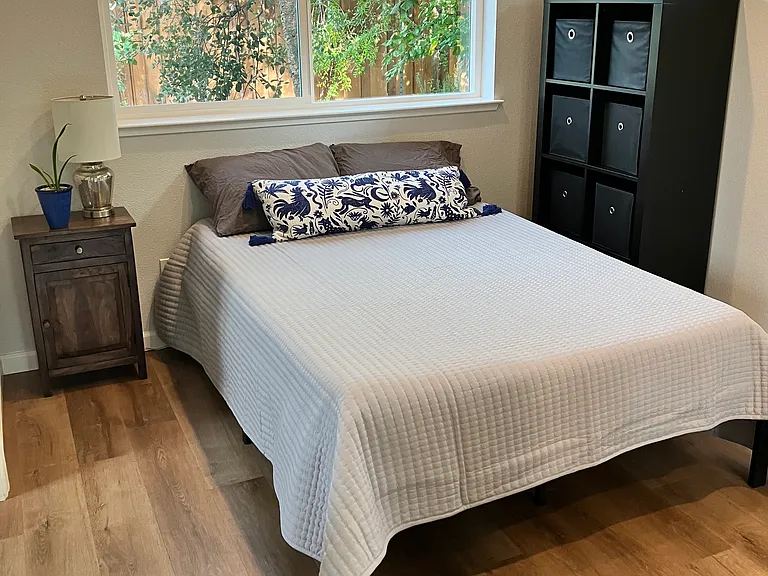 Full size bed with new mattress, new organic sheet set, and new pillows. Black-out shades are installed on all bedroom windows. Spacious closet with sliding mirror doors.