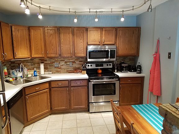 Kitchen has newer stainless steel appliances and stone backs