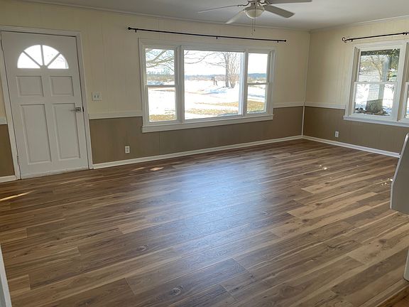 Large (14'x22') living room with picture window and ceiling fan. New laminate flooring.