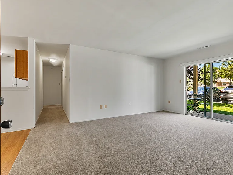 Spacious Living Room with Sliding Glass Doors Leading to Private Patio or Balcony