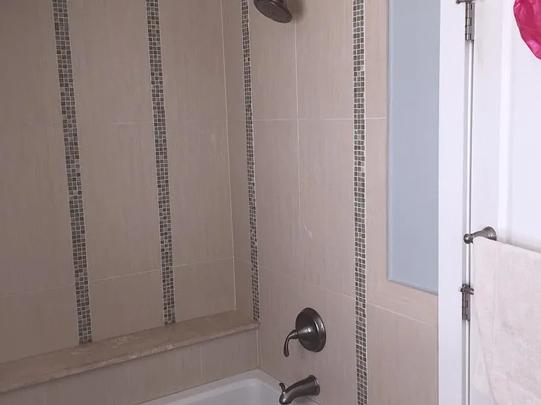Second floor bath with tiled shower same as photo 11.