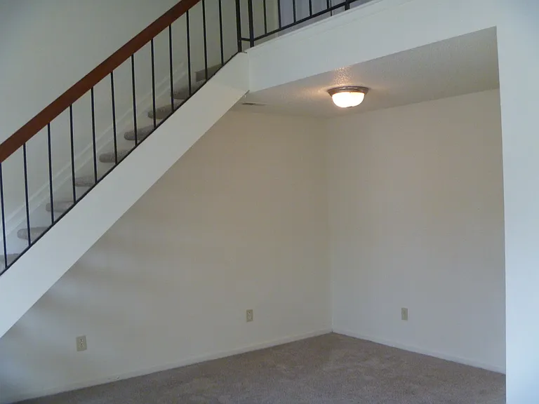 Dining area with staircase going up to second bedroom and bath.