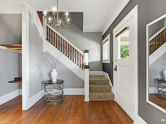 Hardwood floors are virtually throughout the main level. A timeless staircase with formal wood balustrades keeps the area feeling open and grand.>