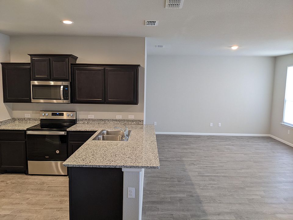 kitchen with granite stone top is open to spacious living room