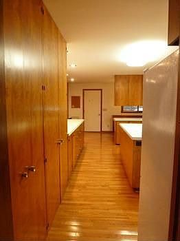 This spacious kitchen with open floor plan includes rich wood finishes,solid wood cabinets and counters galore, a built in breakfast nook and a convenient office area.